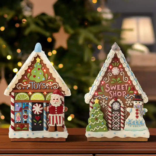 Two decorative gingerbread house lights with 'Toys' and 'Sweet Shop' text, set against a Christmas tree background.